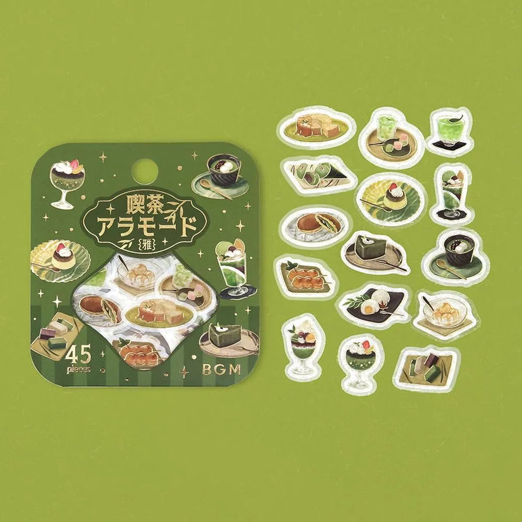 Green matcha-themed café flake sticker sheet with illustrated desserts, tea bowls and small plates accented with foil.