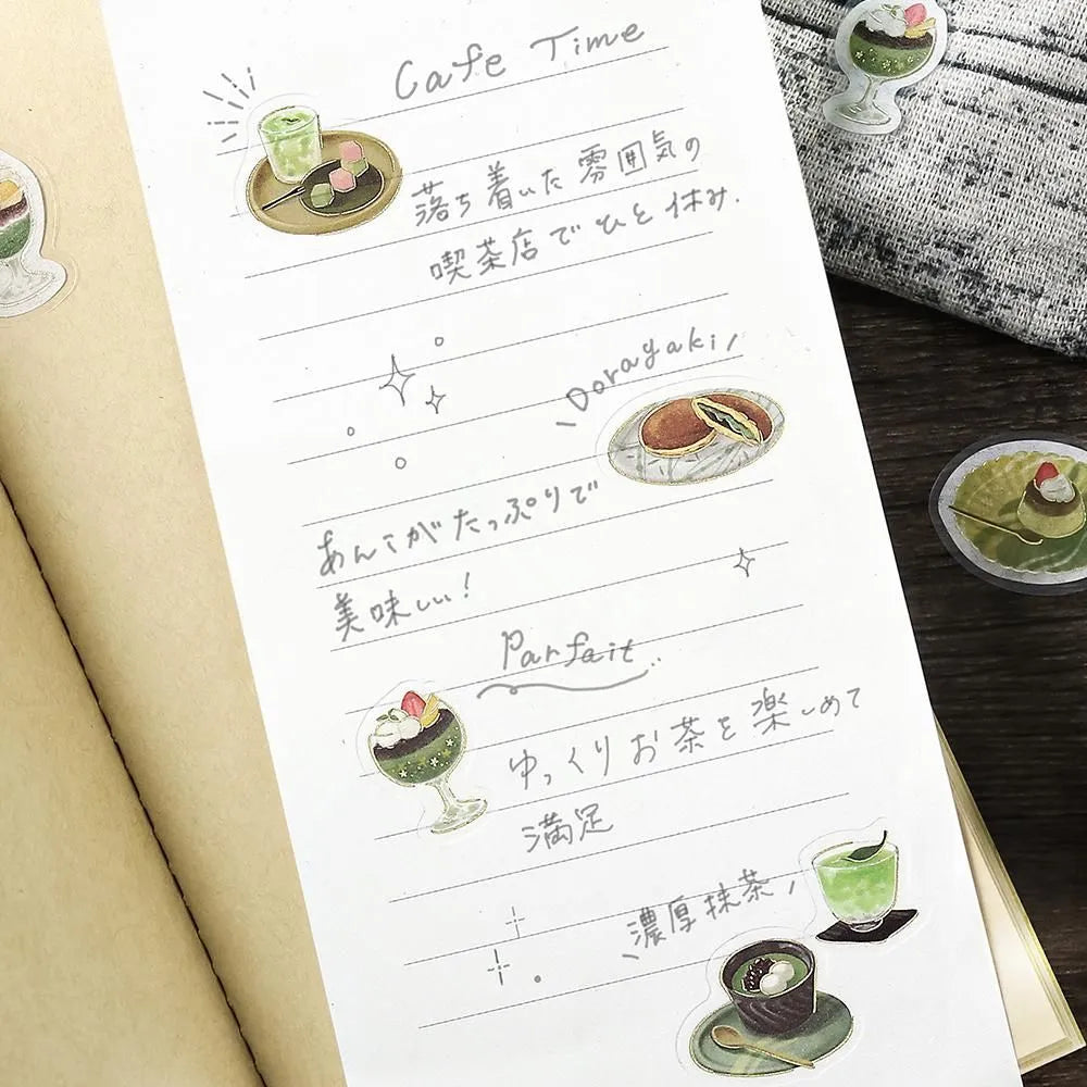 Green matcha-themed café flake sticker sheet with illustrated desserts, tea bowls and small plates accented with foil.