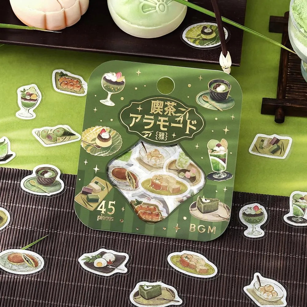 Green matcha-themed café flake sticker sheet with illustrated desserts, tea bowls and small plates accented with foil.