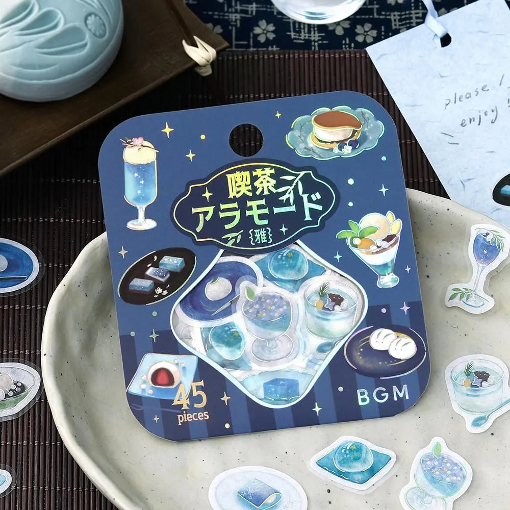 Sheet of blue-themed café flake stickers showing petite plates, parfaits, jelly desserts and drinks with shimmering foil highlights.