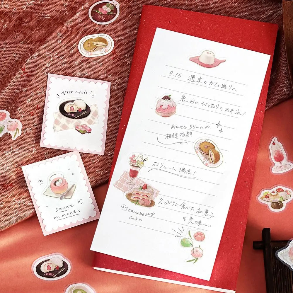 Pink-toned café flake stickers showing cakes, parfaits and delicate desserts with warm foil accents on washi paper.