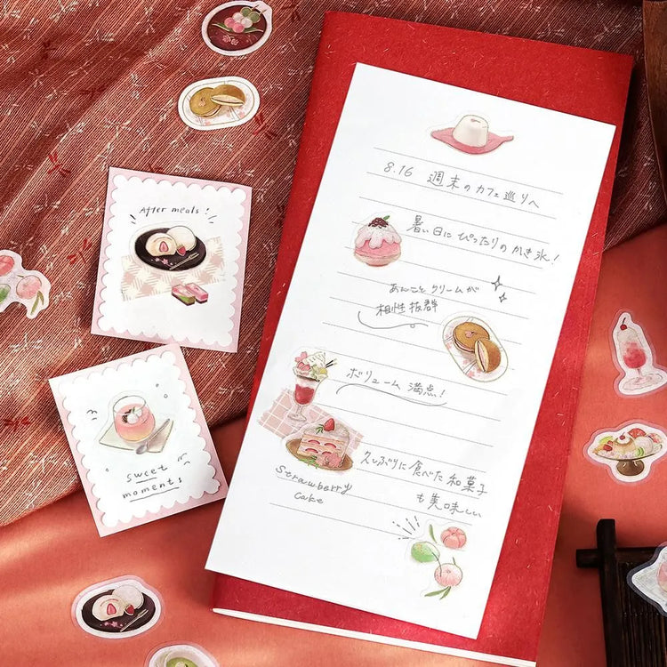 Pink-toned café flake stickers showing cakes, parfaits and delicate desserts with warm foil accents on washi paper.