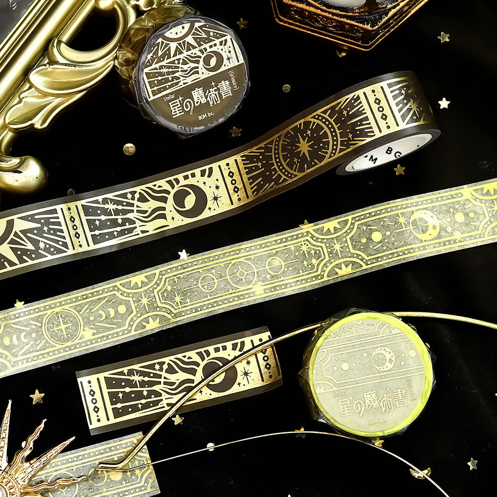 A roll of gold-toned washi tape with celestial suns, moons, and foil accents from the Grimoire of Stars Holy edition.