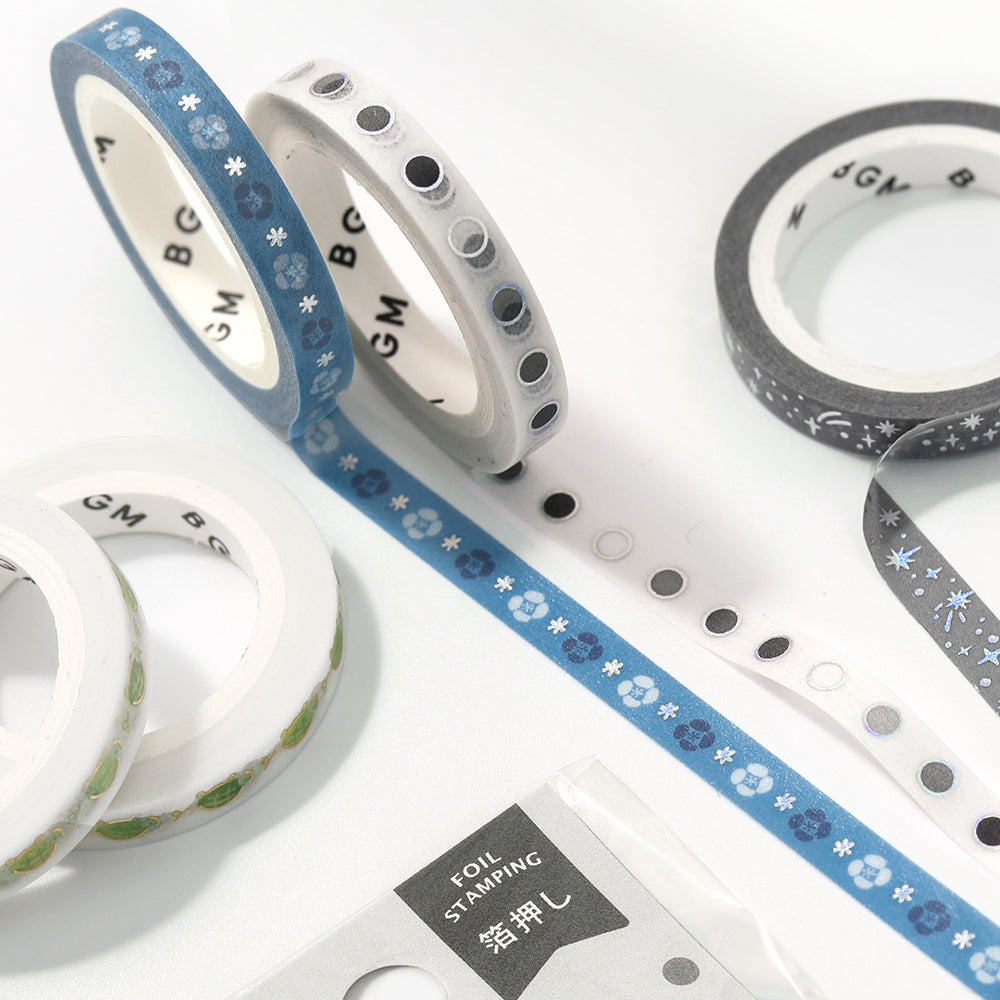 A slim 5mm wide washi tape roll with metallic foil round patterns, perfect for decorating planners, journals, and crafts with a clean modern touch.