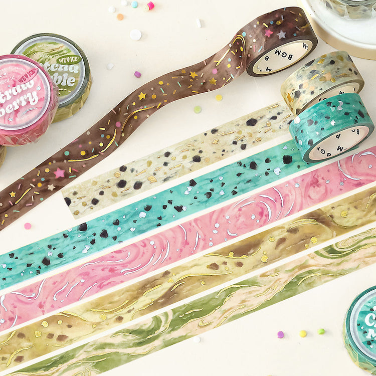 A roll of BGM washi tape in a caramel-inspired design with golden foil accents, styled to resemble sweet dessert drizzles, ideal for journaling, scrapbooking, and decoration.