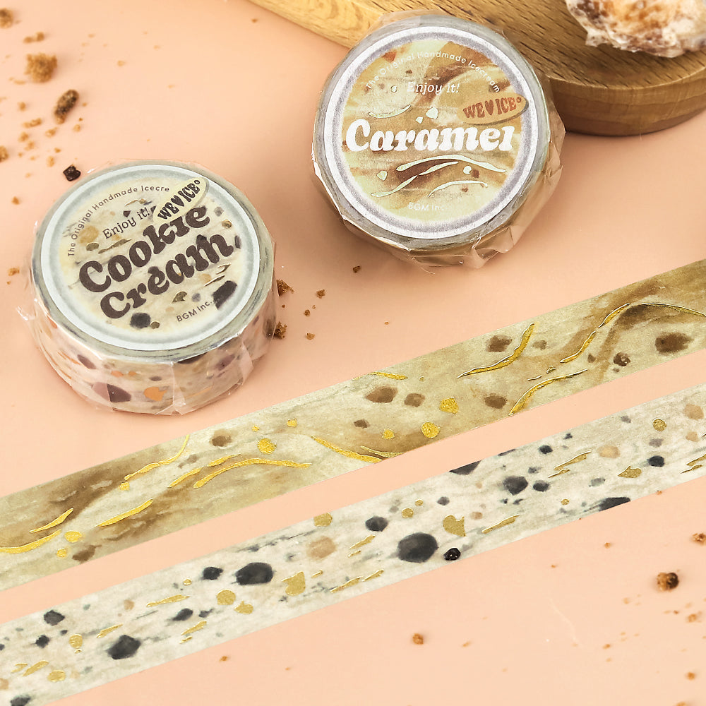 A roll of BGM washi tape in a cookies-and-cream design with foil-stamped cookie specks, styled to resemble the classic dessert, ideal for journaling and creative projects.