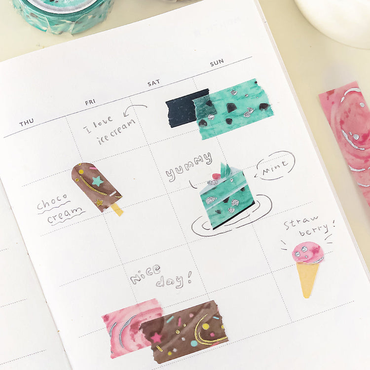 A roll of BGM washi tape in a strawberry-inspired pink design with metallic foil accents, resembling sweet ice cream patterns, ideal for journaling, scrapbooking, and creative decoration.
