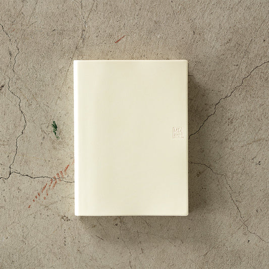 MD Notebook Diary (A5) 1 Day 1 Page 2026 with a minimalist PVC cover, year-stamped spine, and index tabs for each month. The diary is open to show a clean daily page layout on premium MD PAPER, ideal for journaling or planning.
