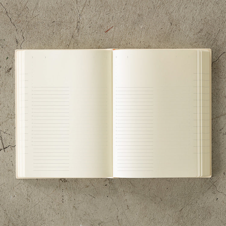MD Notebook Diary (A5) 1 Day 1 Page 2026 with a minimalist PVC cover, year-stamped spine, and index tabs for each month. The diary is open to show a clean daily page layout on premium MD PAPER, ideal for journaling or planning.