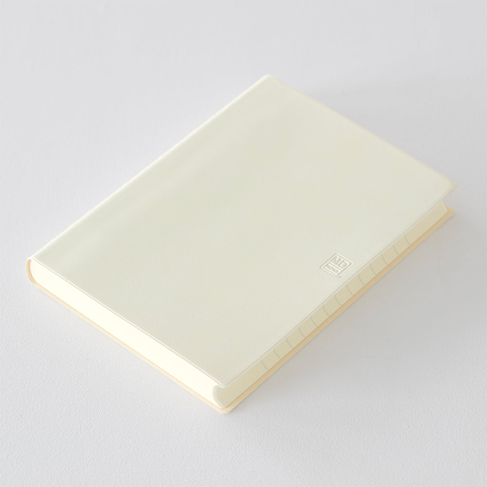 MD Notebook Diary (A5) 1 Day 1 Page 2026 with a minimalist PVC cover, year-stamped spine, and index tabs for each month. The diary is open to show a clean daily page layout on premium MD PAPER, ideal for journaling or planning.