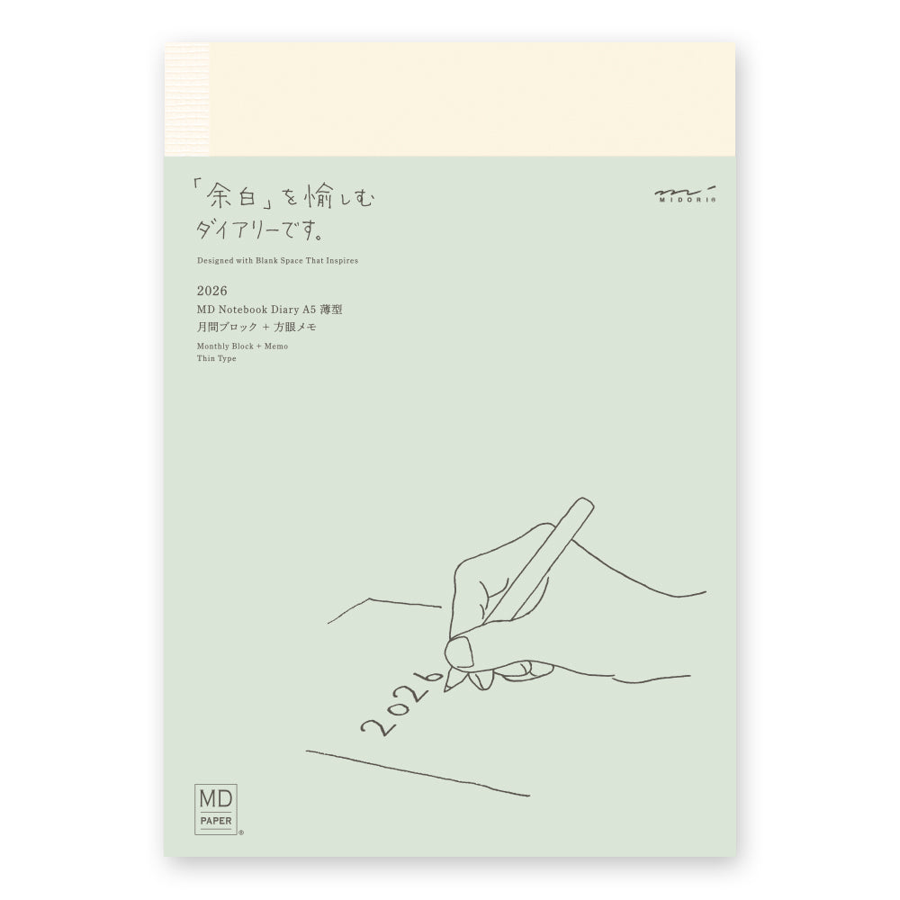 MD Notebook Diary (A5) Thin 2026 – A slim, thread-bound diary with a minimalist cream cover and glassine paper wrap, featuring monthly schedule pages, 5mm grid memo pages, and a bookmark string. Compact and lightweight, designed for portability and everyday use.
