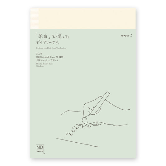 MD Notebook Diary (A5) Thin 2026 – A slim, thread-bound diary with a minimalist cream cover and glassine paper wrap, featuring monthly schedule pages, 5mm grid memo pages, and a bookmark string. Compact and lightweight, designed for portability and everyday use.