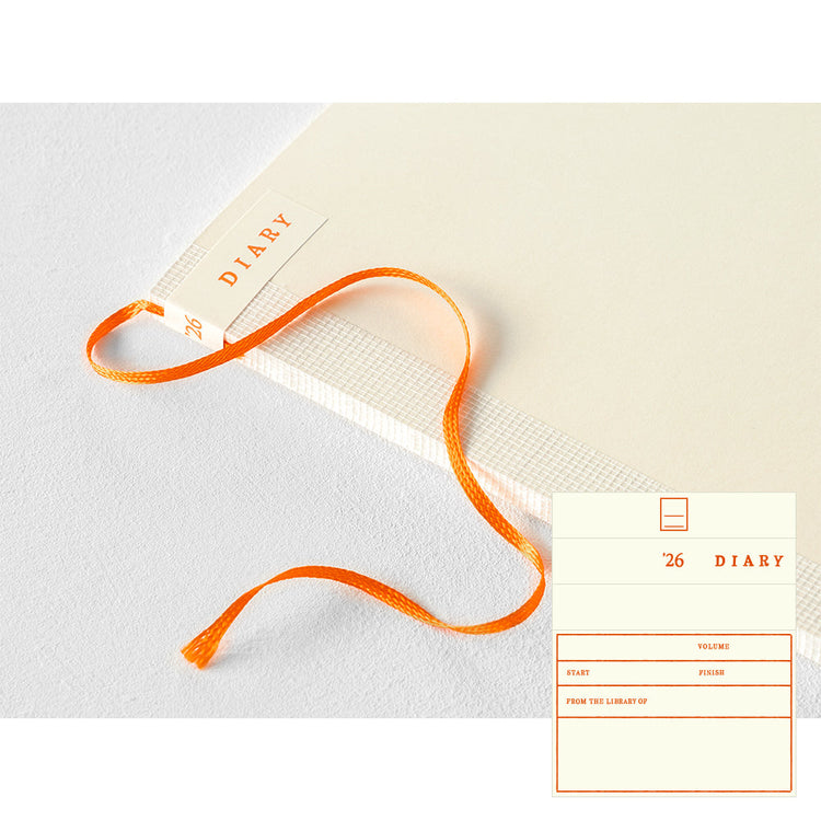 MD Notebook Diary (A5) Thin 2026 – A slim, thread-bound diary with a minimalist cream cover and glassine paper wrap, featuring monthly schedule pages, 5mm grid memo pages, and a bookmark string. Compact and lightweight, designed for portability and everyday use.