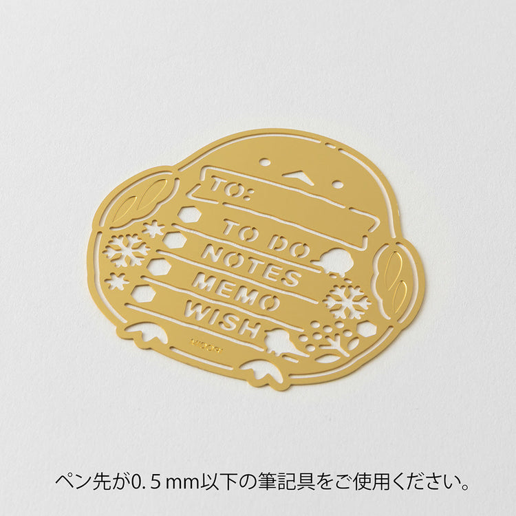 A slim brass stencil with cut-out illustrations of long-tailed tits, snowflakes, berries, and checklist boxes, designed for decorating planners, notebooks, and memos.