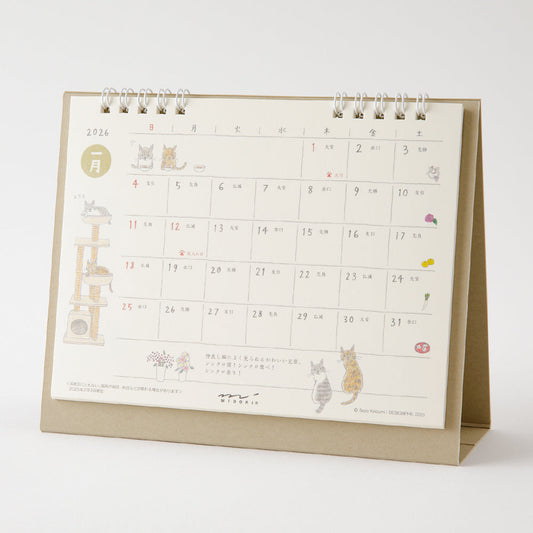 Midori Calendar Ring 2026 (M) – Cat, a freestanding desk calendar with soft, hand-drawn illustrations by Sayo Koizumi, depicting playful and cozy scenes of cats throughout the year.