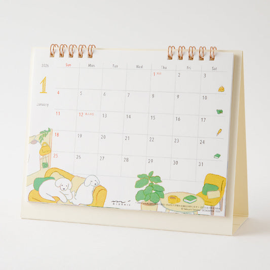 Midori Calendar Ring 2026 (M) – Dog, a compact desk calendar with colorful dog illustrations by Natsumi Teraoka, displayed upright to show its charming, hand-drawn monthly design.