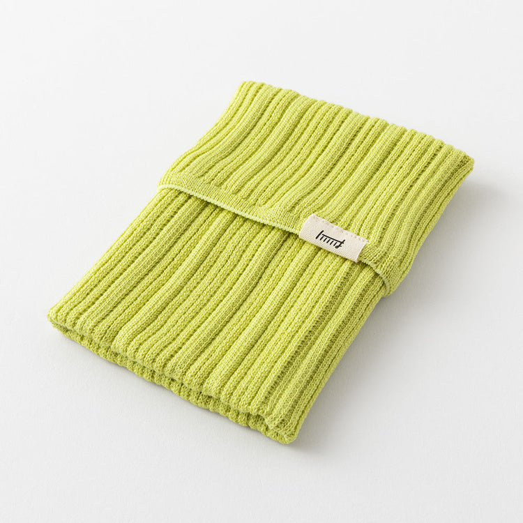 Midori Notebook’s HARAMAKI A6～B6 in Lime Yellow, shown in packaging. A soft cable-knit pouch with flap cover, designed to wrap around a planner like a belly warmer, with stretchable pockets for pens and small essentials.