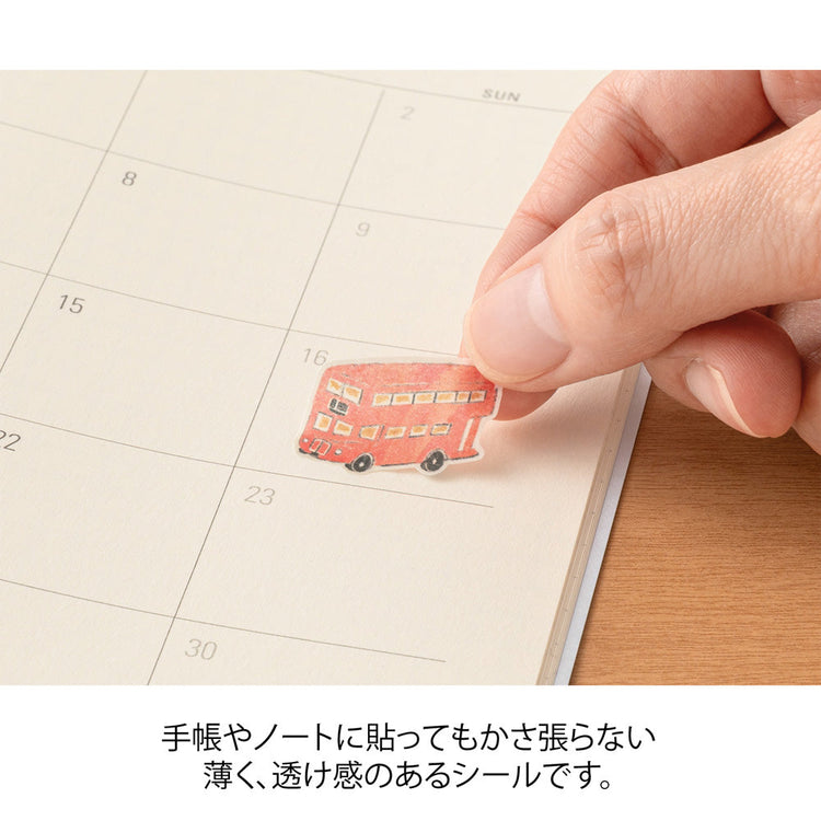 Sheet of Midori washi stickers illustrated by Yuuka Takamaru, featuring soft-toned British motifs such as teacups, flowers, patterned frames, and iconic landmarks. The elegant designs evoke the charm of British culture and are perfect for decorating planners and journals.