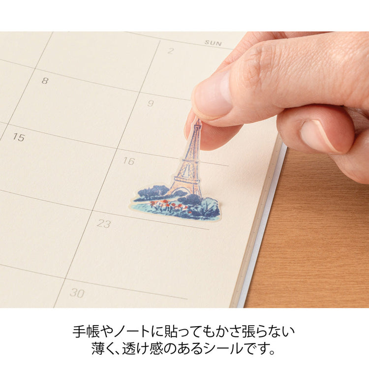 A sheet of Midori French Motifs washi stickers illustrated by Yuuka Takamaru, featuring  frame stickers with traditional patterns, along with distinctive motifs like local foods, animals, flowers, and landmarks. The soft pastel colors give the sheet an elegant and travel-inspired feel, ideal for decorating planners and notebooks.