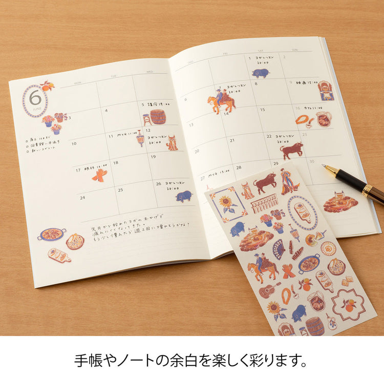 A sheet of Midori Spanish Motifs washi stickers by Yuuka Takamaru, featuring playful illustrations such as flamenco dancers, paella, bulls, guitars, and colorful Spanish tile patterns. Designed in soft pastel hues, these stickers evoke the lively charm and warmth of Spain.