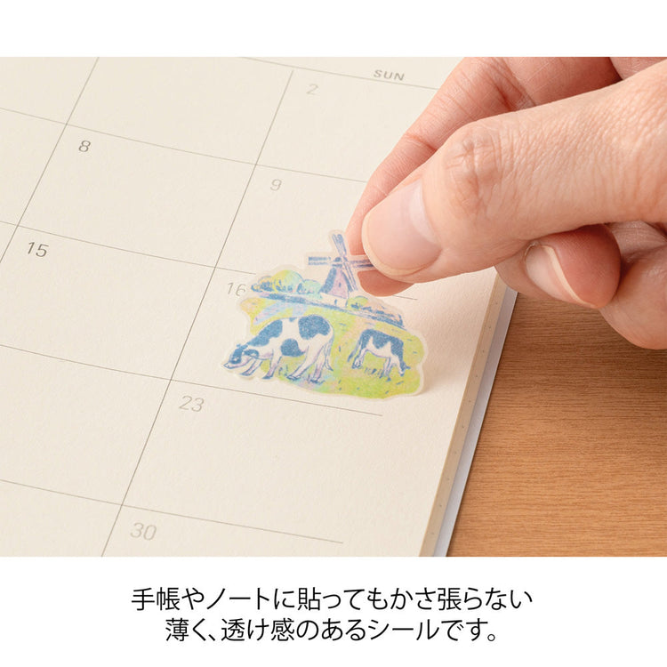 A sheet of Midori Dutch Motifs washi stickers illustrated by Yuuka Takamaru, with charming designs of tulips, windmills, bicycles, clogs, and folk-style frames in soft pastel tones, evoking the cheerful spirit of the Netherlands.