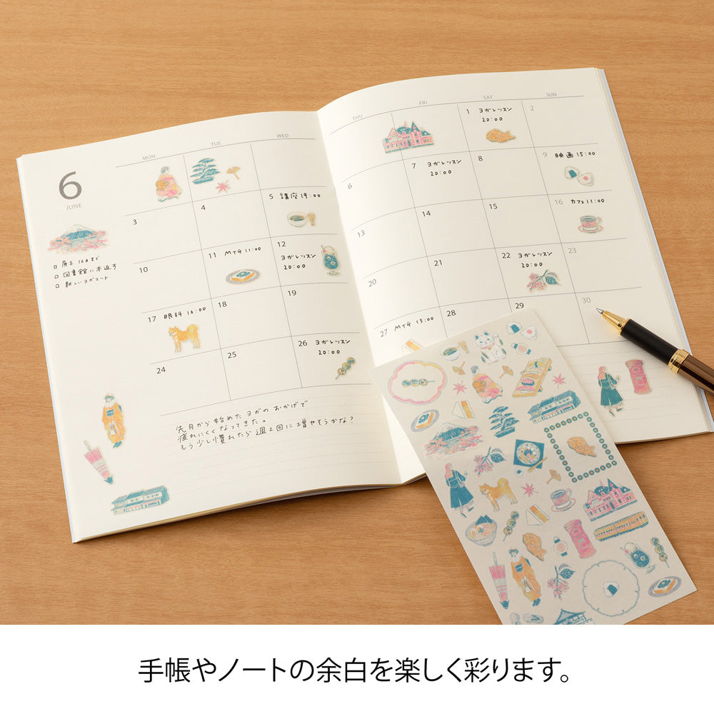 A sheet of Midori Sticker 2719 featuring delicate washi stickers of Japanese motifs, including cherry blossoms, Mount Fuji, seasonal foods, and traditional frame patterns in Yuuka Takamaru’s soft, pastel color palette.