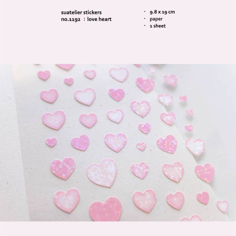 A single sheet of Suatelier Daily Deco Sticker – Love Heart, featuring rows of hand-drawn heart illustrations in different shapes, colors, and sizes on translucent paper.