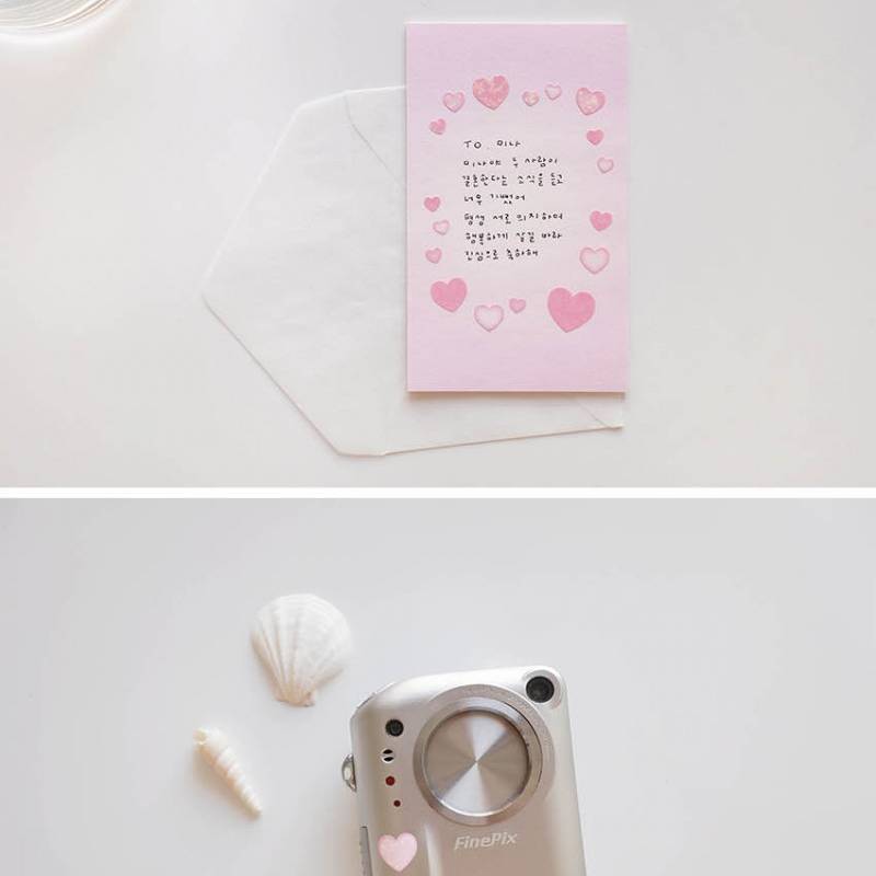 A single sheet of Suatelier Daily Deco Sticker – Love Heart, featuring rows of hand-drawn heart illustrations in different shapes, colors, and sizes on translucent paper.