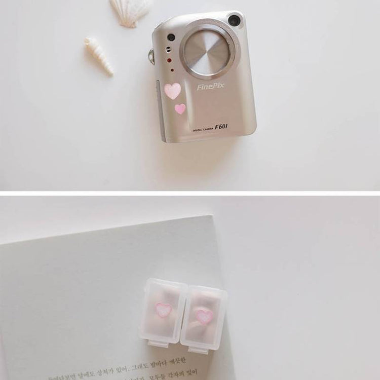 A single sheet of Suatelier Daily Deco Sticker – Love Heart, featuring rows of hand-drawn heart illustrations in different shapes, colors, and sizes on translucent paper.