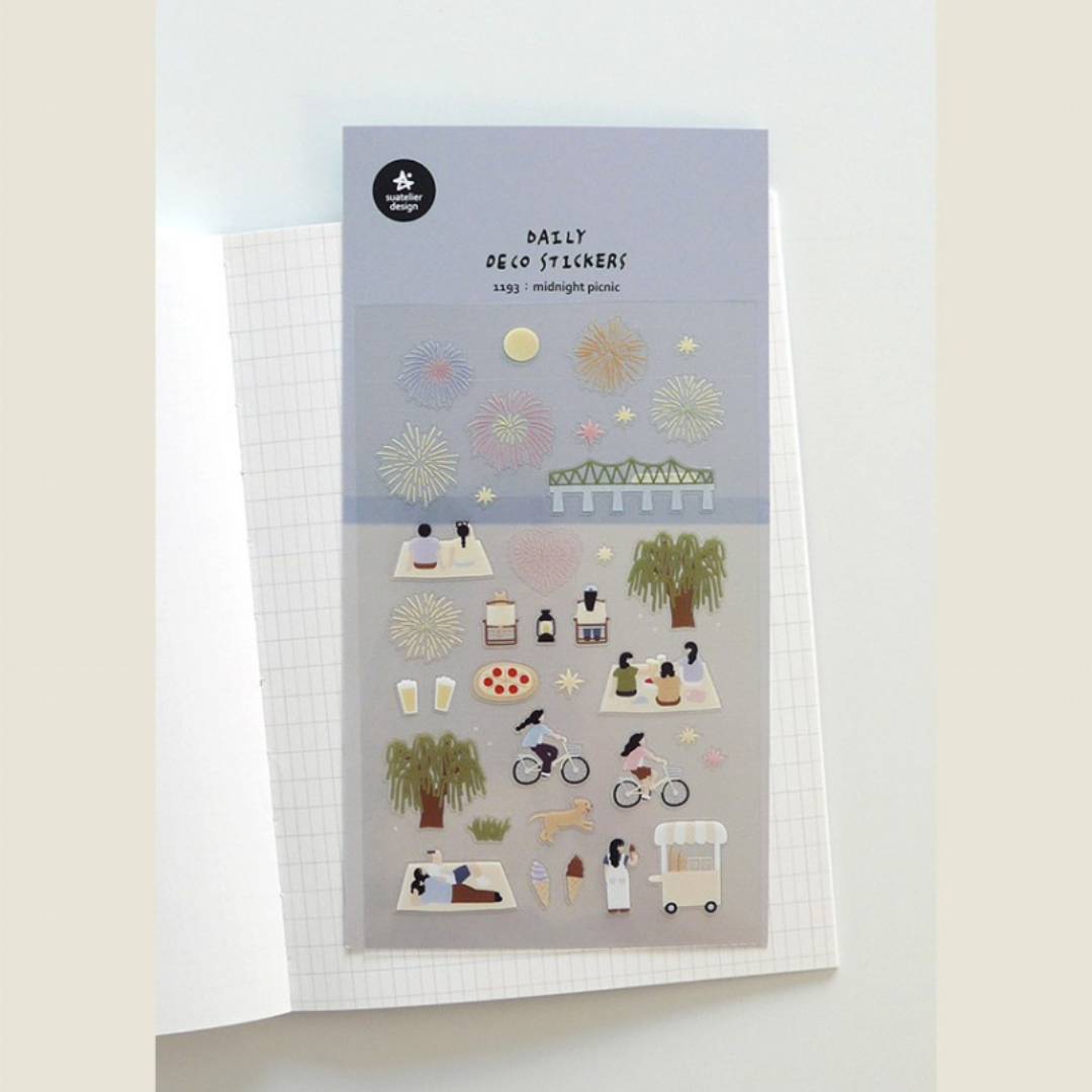 A sheet of decorative stickers featuring illustrations of fireworks, picnic blankets, pizza, drinks, people cycling, dogs, ice cream, and night sky scenes—perfect for journaling and capturing the atmosphere of a summer midnight picnic.