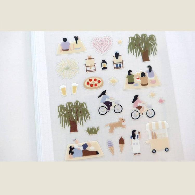 A sheet of decorative stickers featuring illustrations of fireworks, picnic blankets, pizza, drinks, people cycling, dogs, ice cream, and night sky scenes—perfect for journaling and capturing the atmosphere of a summer midnight picnic.