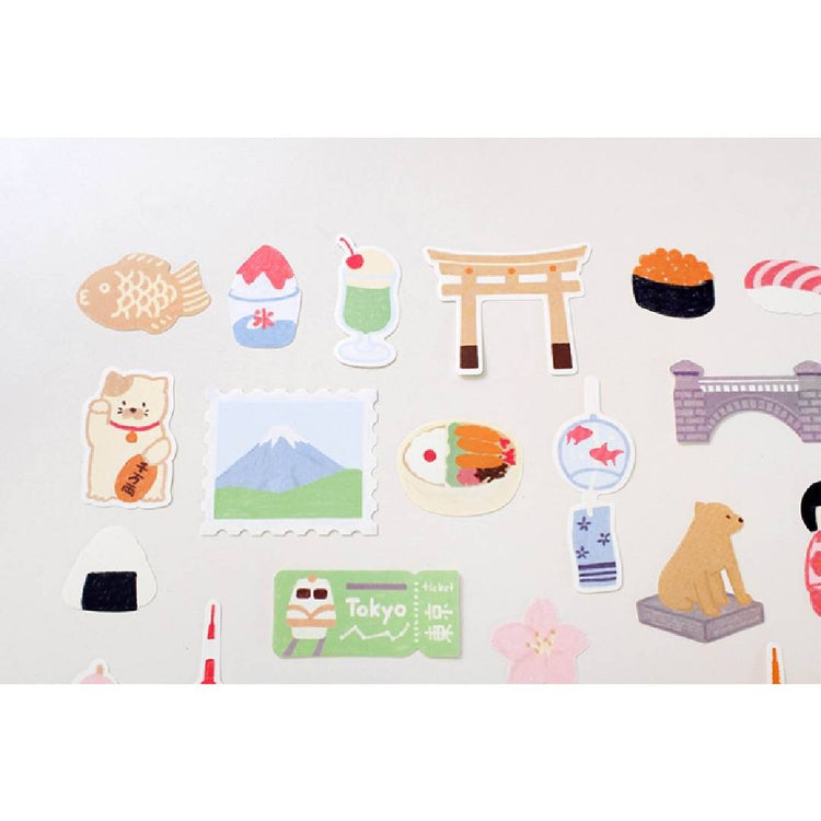 Suatelier Sticker – Tokyo Travel Diary featuring 28 illustrated Tokyo motifs such as landmarks, street food, and city scenes on a 15×17 cm coated paper sheet.