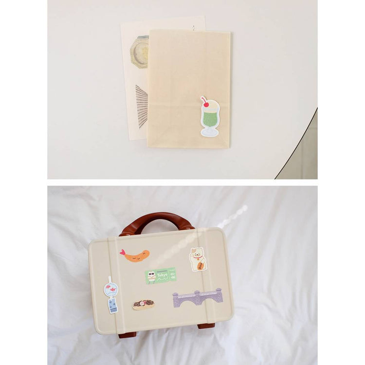 Suatelier Sticker – Tokyo Travel Diary featuring 28 illustrated Tokyo motifs such as landmarks, street food, and city scenes on a 15×17 cm coated paper sheet.